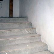 How is a concrete staircase finished with wood