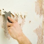 How is the preparation of concrete walls for wallpapering