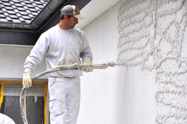 Applying a second coat of plaster coat