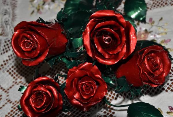 Wrought iron roses in red and green patina