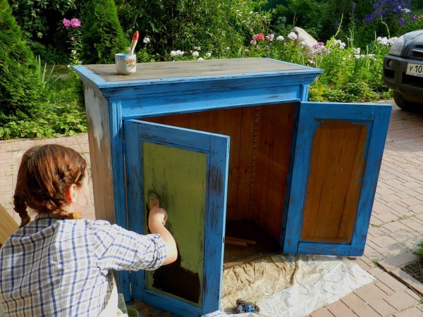 The process of painting a wooden cabinet