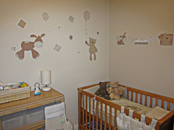 Beige-brown children's room with cartoon characters on the wallpaper