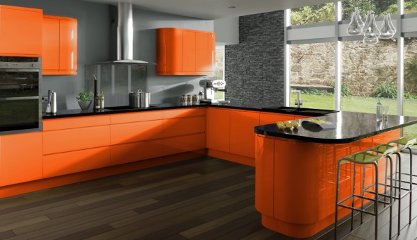 Pictured is an orange kitchen with gray walls