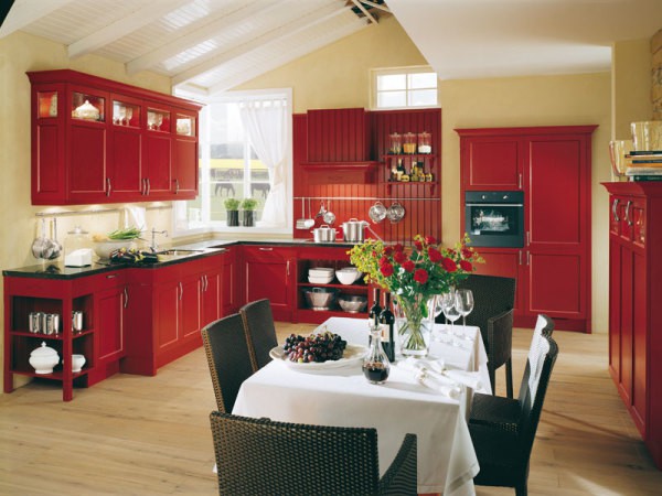 Light paint on the walls of the kitchen combined with red furniture