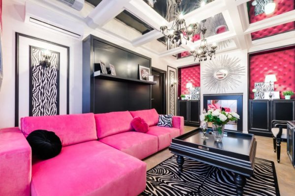 Pink and black furniture on a background of white wallpaper with pink accents