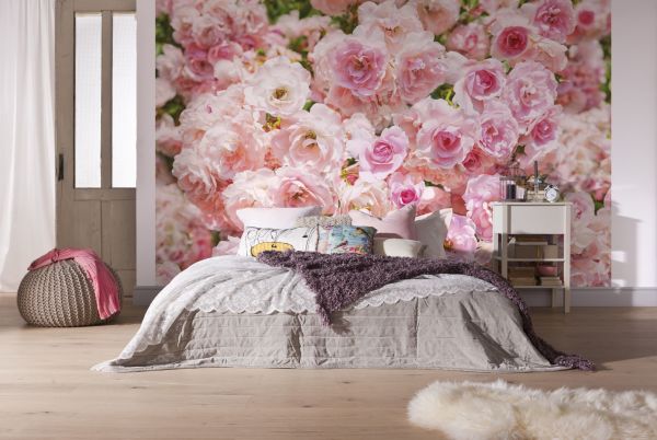 Wall mural pink roses, in the interior of a bright bedroom