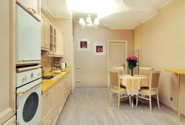 Kitchen in delicate cream colors with yellow and white accents