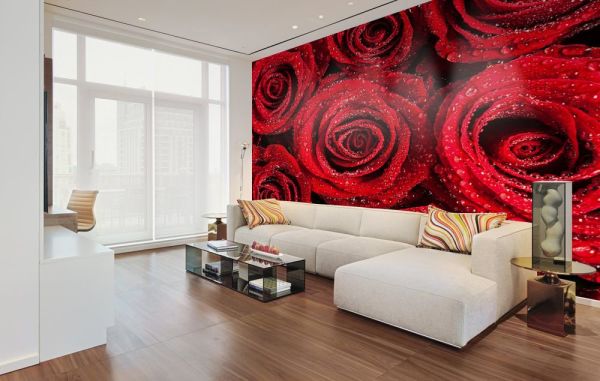 Bright red roses on a mural in the interior of a white living room