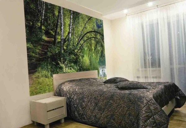 Wall mural with the image of a forest path in the interior of an ordinary bedroom