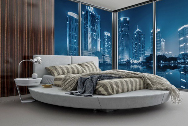 Wall mural with the image of the night city, bottom view from the river, in the interior of an ultramodern bedroom