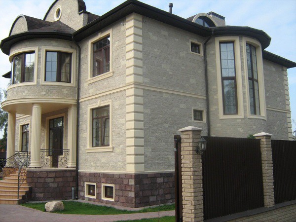 Facing with a tile and a decorative stone of a facade