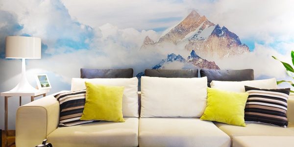 Wall mural with the image of mountain peaks looking out from the thick clouds can visually increase the space of the room in which