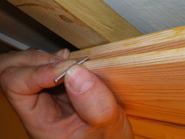 Fastening the lining through the groove of the panel using conventional nails