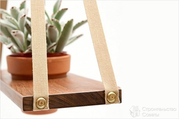 Wooden shelf for flowers on the wall