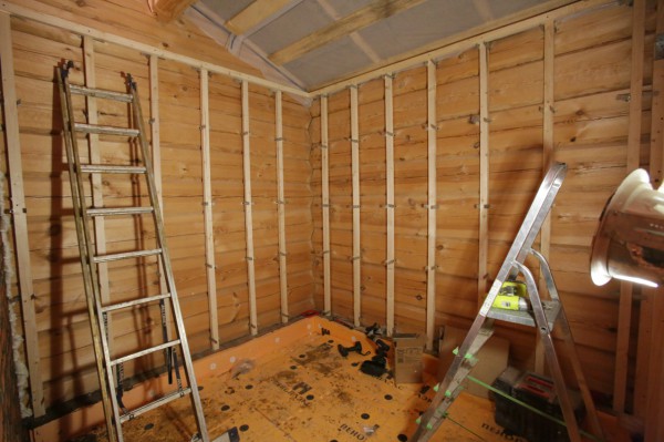 In the photo we see an example of a wooden frame on wooden walls, for covering them with drywall, for leveling and warming