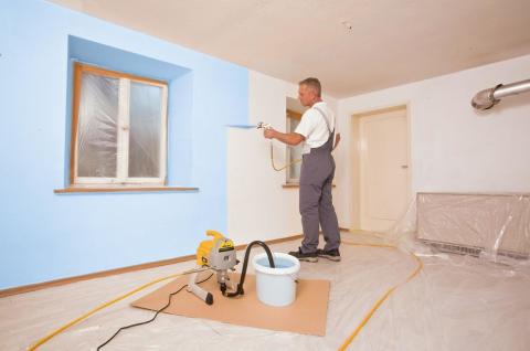 We see the process of painting walls with a pneumatic bullet machine