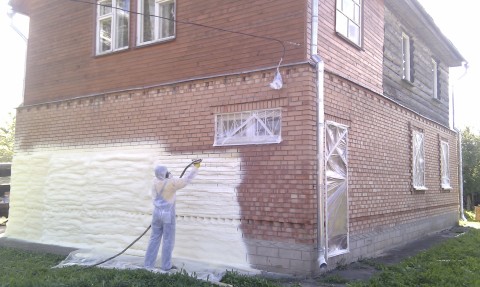 The process of applying polyurethane foam to the exterior walls of a house