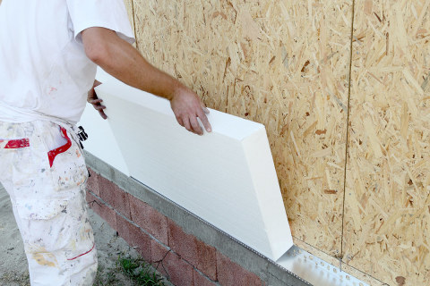 The process of warming the exterior walls of the house with styrene heaters