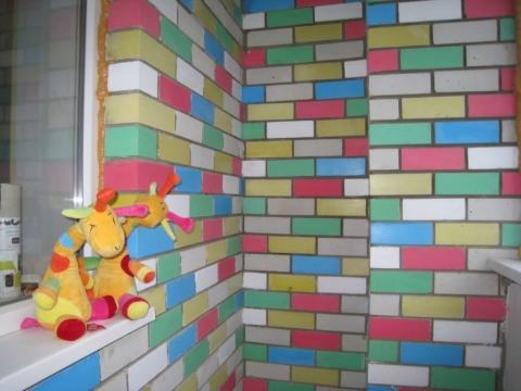 With the help of multi-colored paints for bricks, you can create a children's zone in the yard near the house