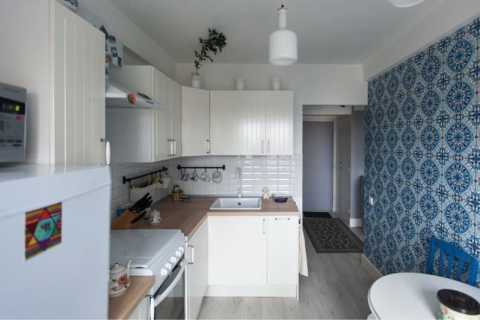 White kitchen on a background of blue wallpaper