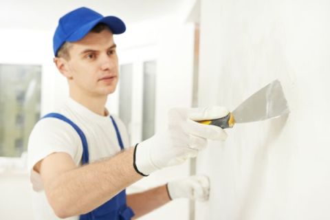 Cleaning with a narrow spatula on the wall surface.