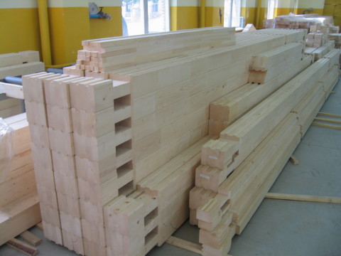 Kit for the construction of a wooden house: numbered blanks are cut to size, selected mounting grooves