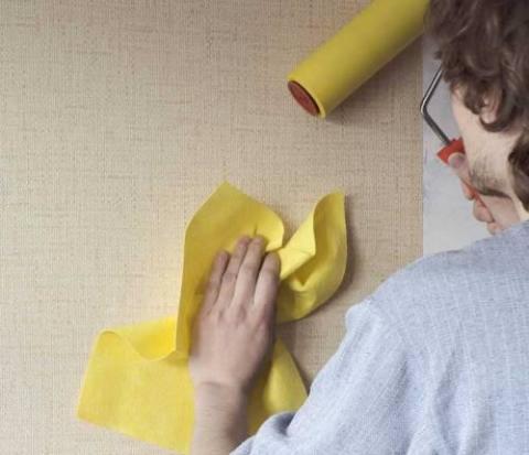 Removing air bubbles from beneath the wallpaper