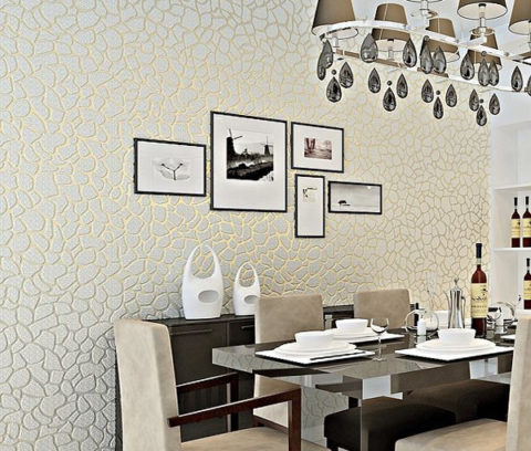 Neutral non-woven wallpaper serves as a backdrop for decorative elements.