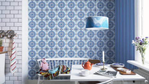 The combination of different wallpaper patterns makes the kitchen space dynamic