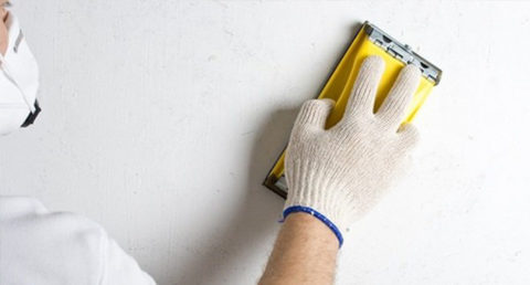 Grinding walls with a hand grater