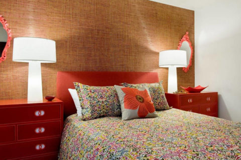 Warm bedroom interior with textile wallpaper on an accent wall