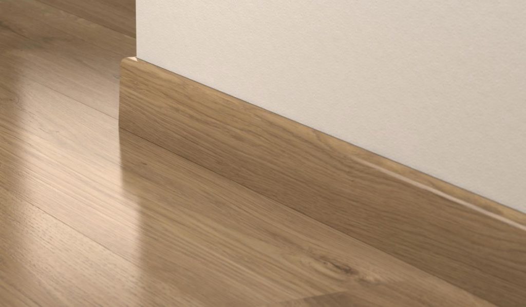 Skirting board in the color of the flooring.