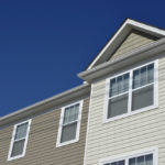 house sheathed with siding under a log photo